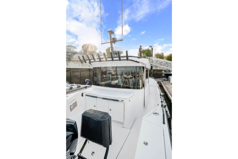 Slide: The Image of 2021 Axopar 37 XC Cross Cabin boat docked, showcasing sleek design and modern features. - 15