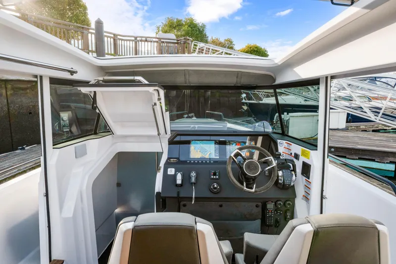 Slide: The Image of Interior view of 2021 Axopar 37 XC Cross Cabin boat cockpit with modern controls. - 20