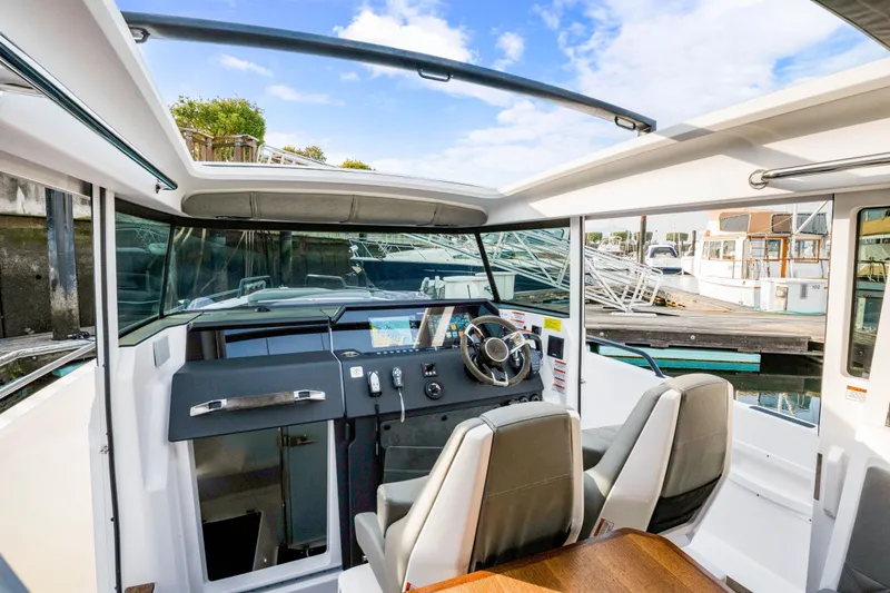 Slide: The Image of Interior view of 2021 Axopar 37 XC Cross Cabin boat with modern dashboard and seating. - 23