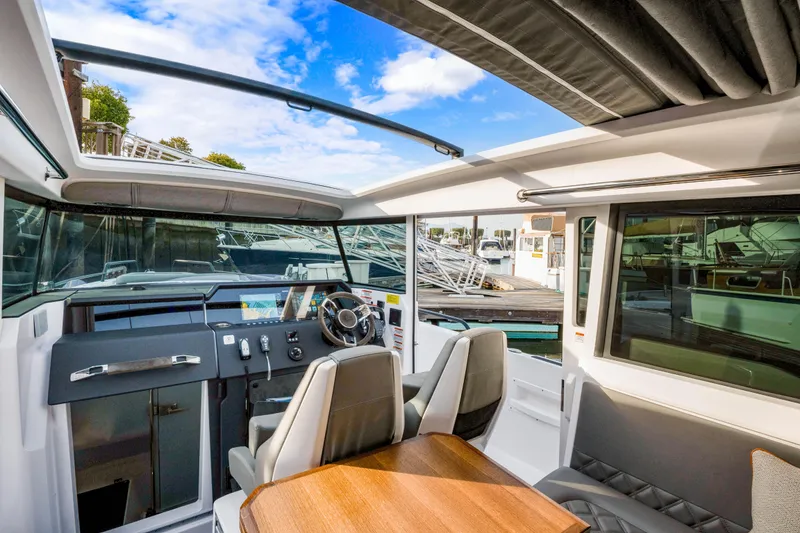 Slide: The Image of Interior of 2021 Axopar 37 XC Cross Cabin with modern helm and seating. - 26