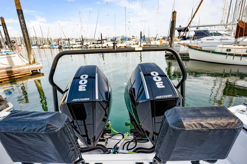 Slide: The Image of 2021 Axopar 37 XC Cross Cabin with twin Mercury 300 engines at marina. - 27