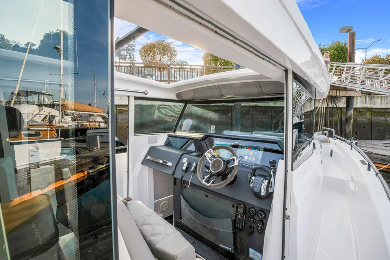 Slide: The Image of 2021 Axopar 37 XC Cross Cabin boat interior with modern dashboard and steering wheel. - 28