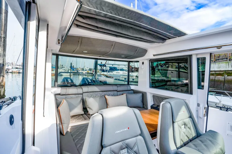 Slide: The Image of Luxurious interior of 2021 Axopar 37 XC Cross Cabin with plush seating and panoramic windows. - 30