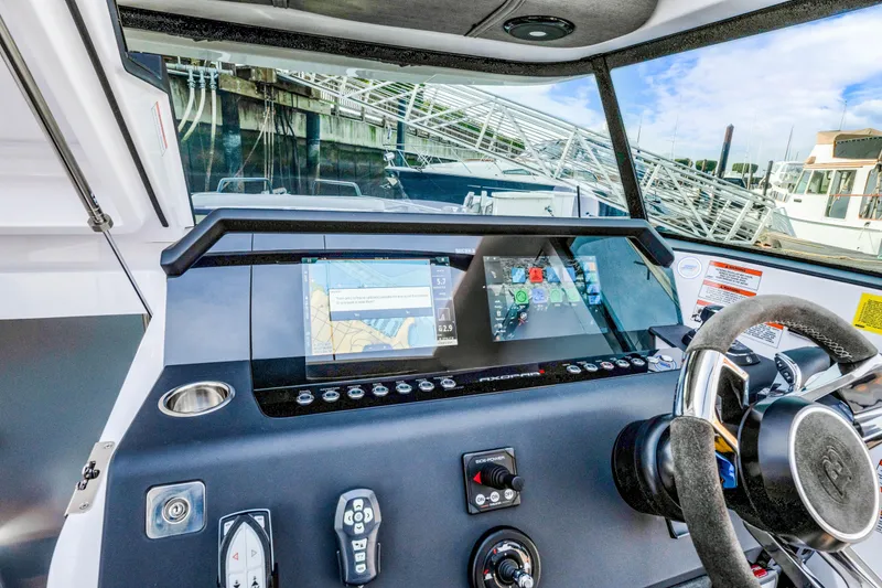 Slide: The Image of 2021 Axopar 37 XC Cross Cabin dashboard with navigation screens and controls. - 31