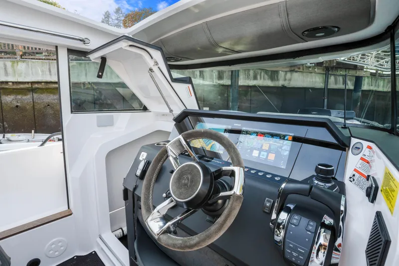 Slide: The Image of 2021 Axopar 37 XC Cross Cabin helm with modern controls and touchscreen display. - 32