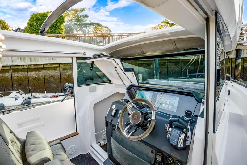 Slide: The Image of 2021 Axopar 37 XC Cross Cabin interior with modern dashboard and steering wheel. - 33