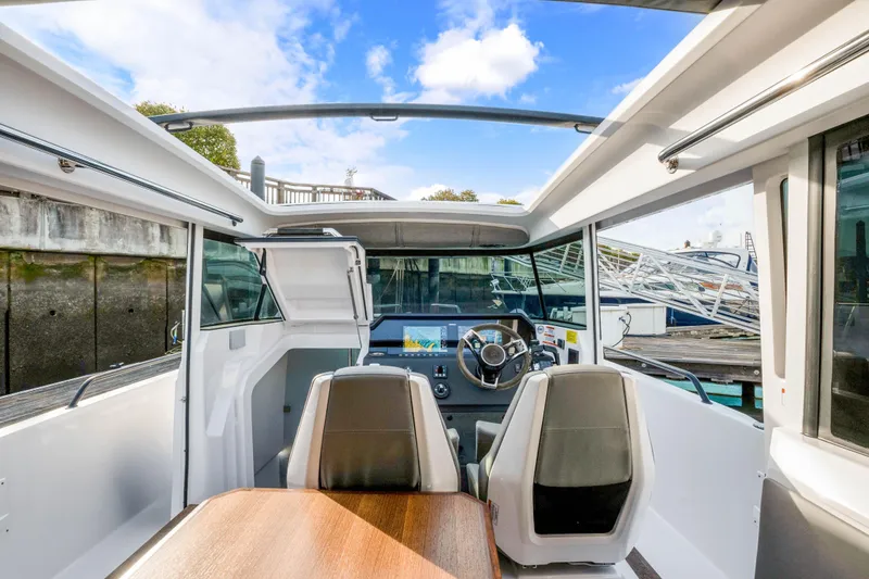 Slide: The Image of Interior view of 2021 Axopar 37 XC Cross Cabin boat with modern helm and seating. - 37