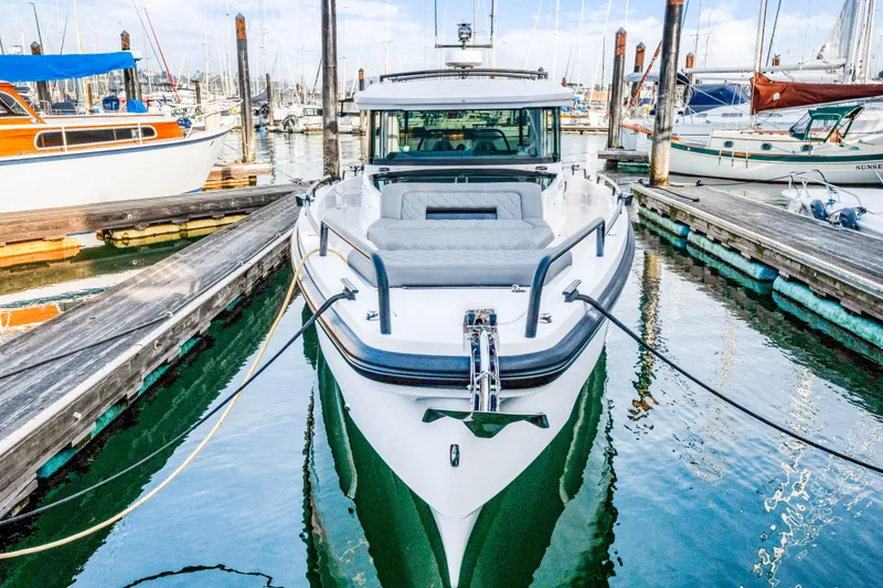 Slide: The Image of 2021 Axopar 37 XC Cross Cabin docked at marina, front view. - 4