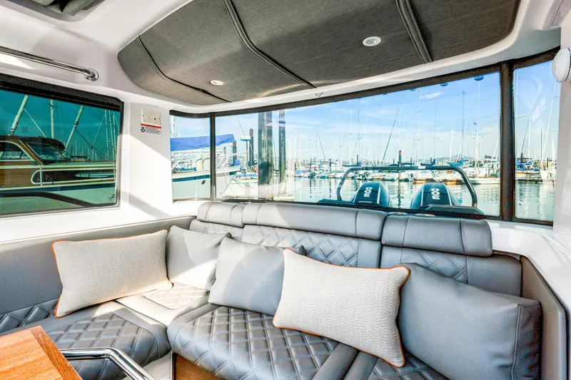 Slide: The Image of Interior of 2021 Axopar 37 XC Cross Cabin with marina view through large windows. - 41