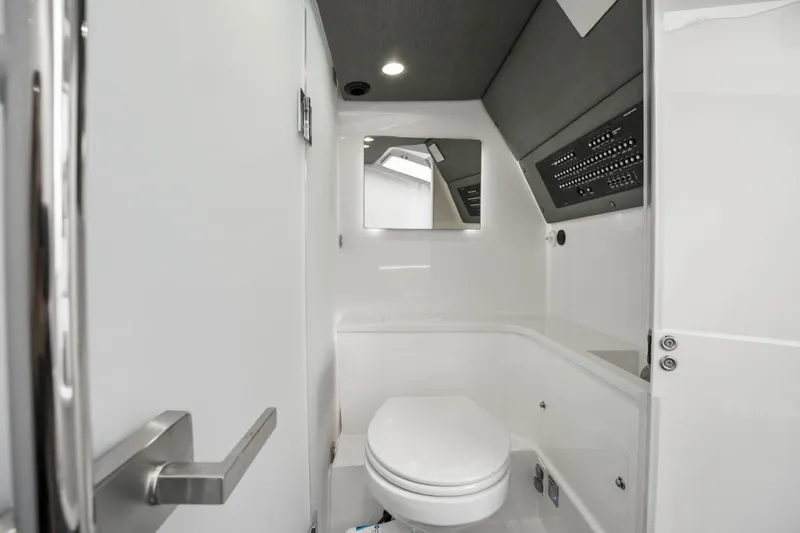 Slide: The Image of 2021 Axopar 37 XC Cross Cabin bathroom with modern white interior and sleek design. - 44