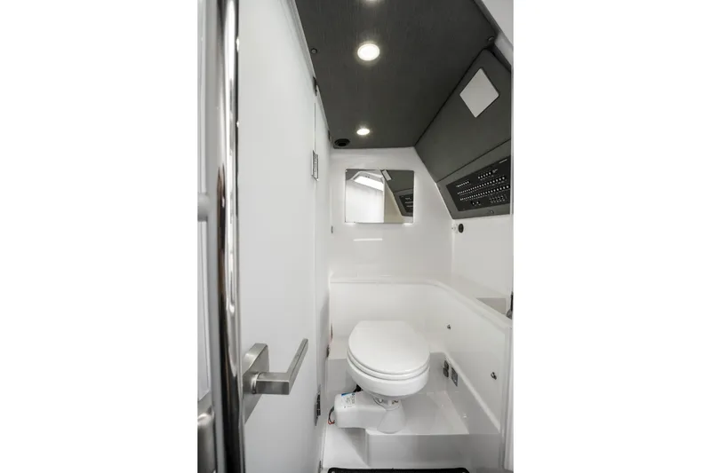 Slide: The Image of 2021 Axopar 37 XC Cross Cabin bathroom interior with modern fixtures and lighting. - 48