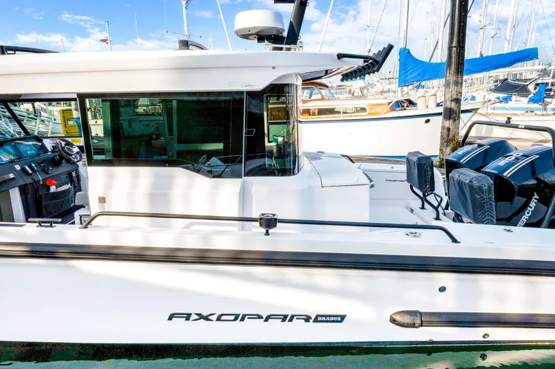 Slide: The Image of 2021 Axopar 37 XC Cross Cabin boat docked, featuring sleek design and powerful engines. - 8