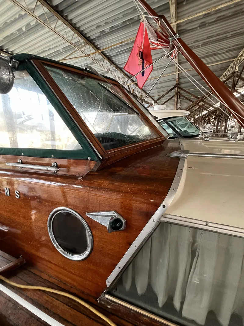 Slide: The Image of 1959 Owens Cabin boat with red flag mast in harbor. - 10