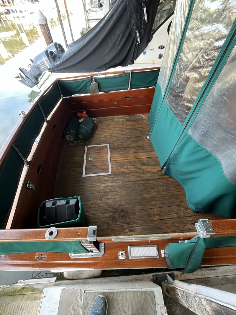 Slide: The Image of 1959 Owens Cabin boat with wooden deck and green cover. - 12