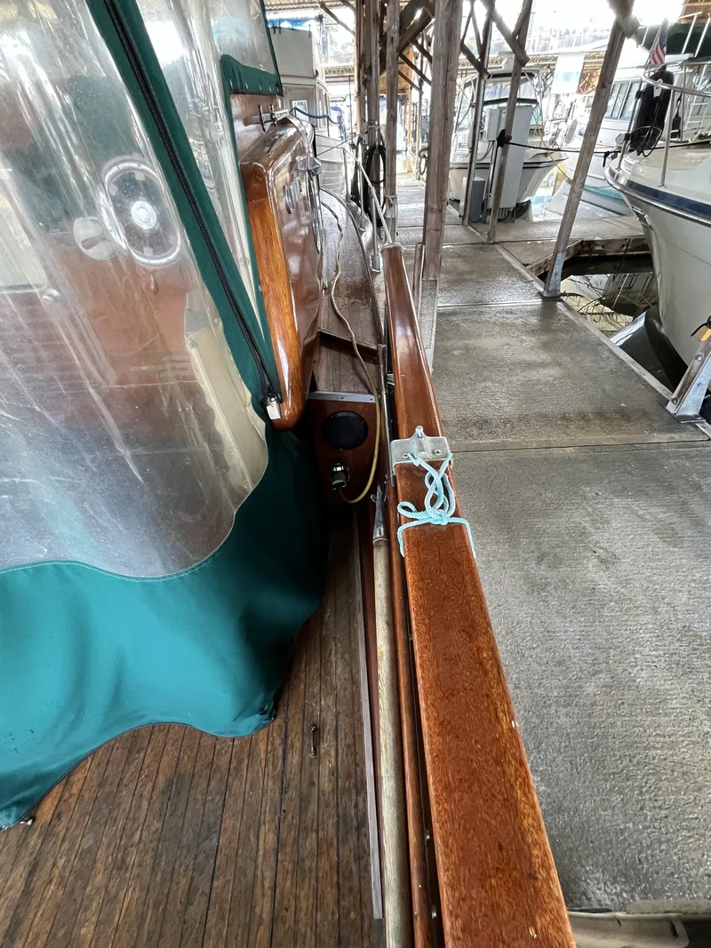 Slide: The Image of 1959 Owens Cabin boat dock with wooden details and green canopy. - 13