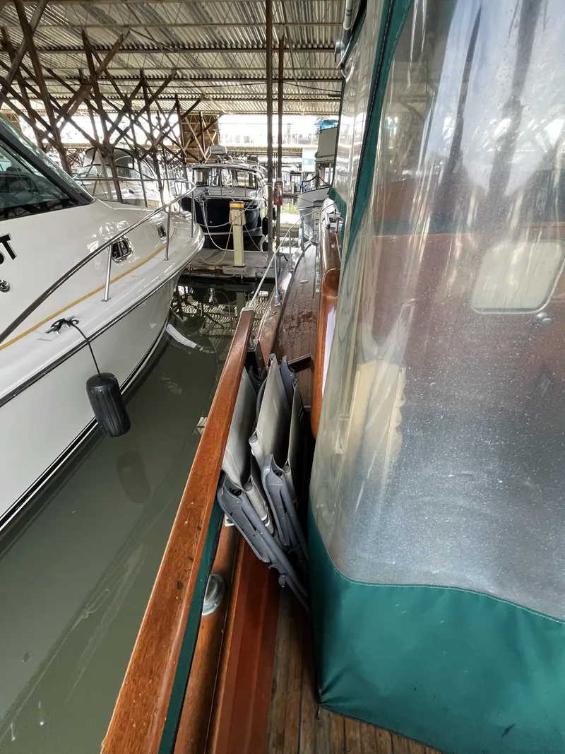 Slide: The Image of 1959 Owens Cabin boat docked alongside other boats. - 14