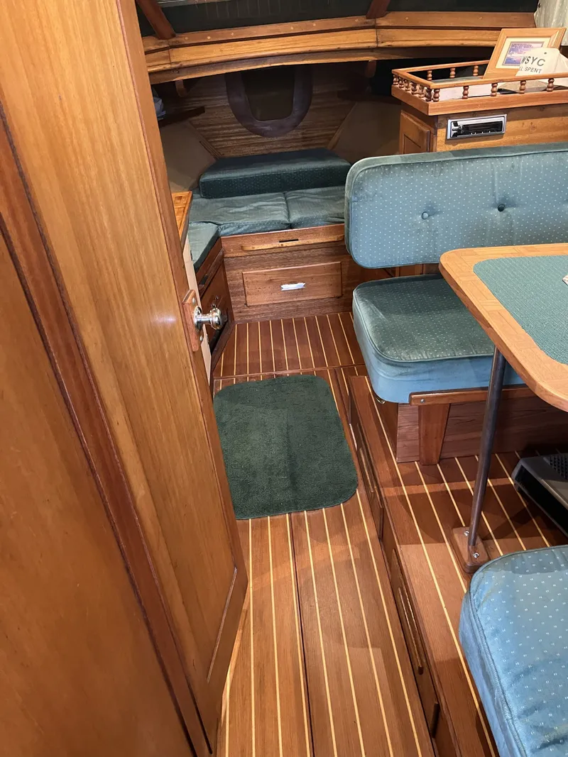 Slide: The Image of Interior of a 1959 Owens Cabin with wood flooring and blue upholstery. - 29