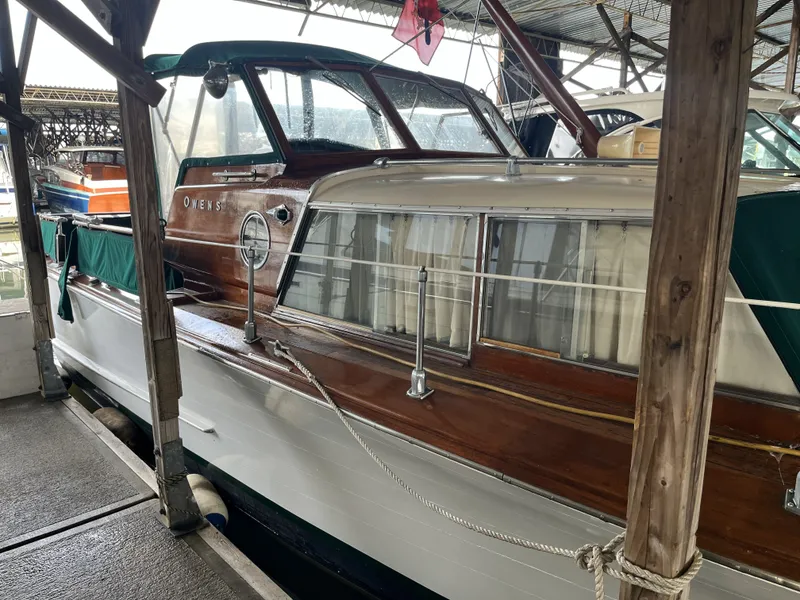 Slide: The Image of 1959 Owens Cabin boat docked, showcasing classic design. - 3