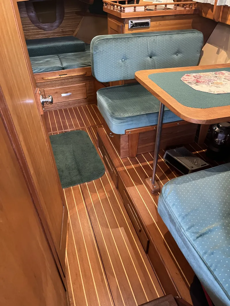 Slide: The Image of Interior of a 1959 Owens Cabin with wood flooring and blue upholstery. - 30