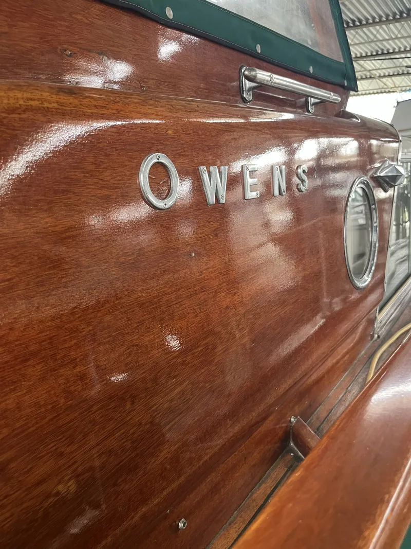 Slide: The Image of 1959 Owens Cabin boat with glossy wood finish. - 31