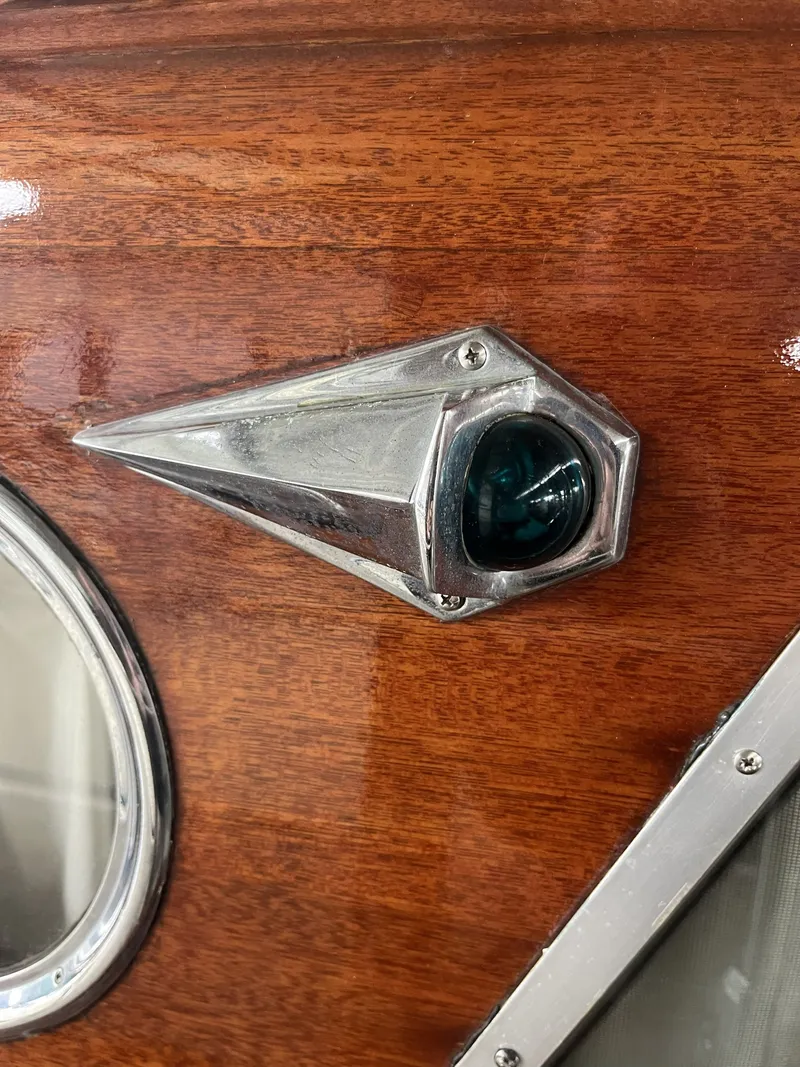 Slide: The Image of 1959 Owens Cabin boat with wood paneling and metal accent. - 32