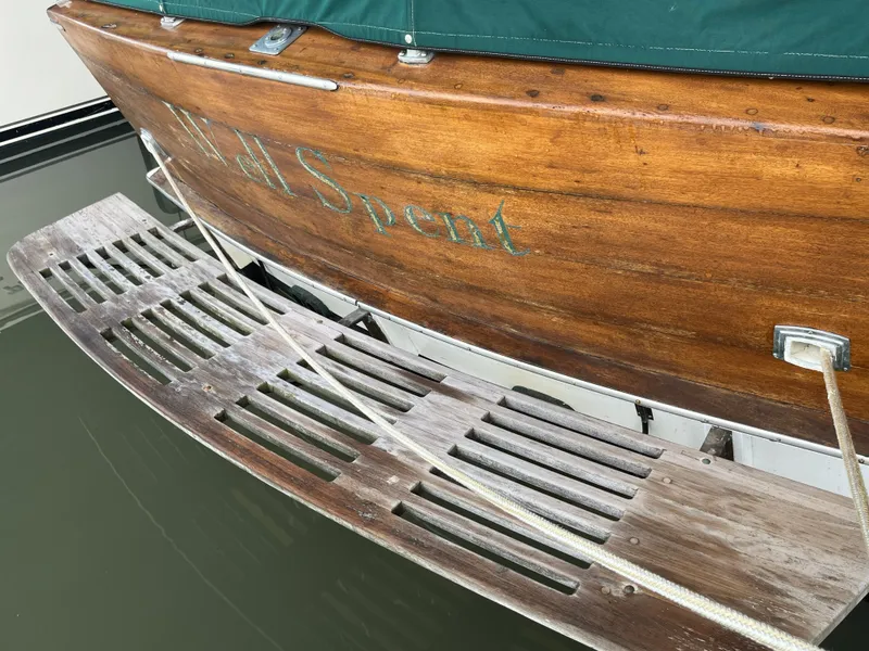 Slide: The Image of Rear view of a 1959 Owens Cabin boat with wooden details. - 5