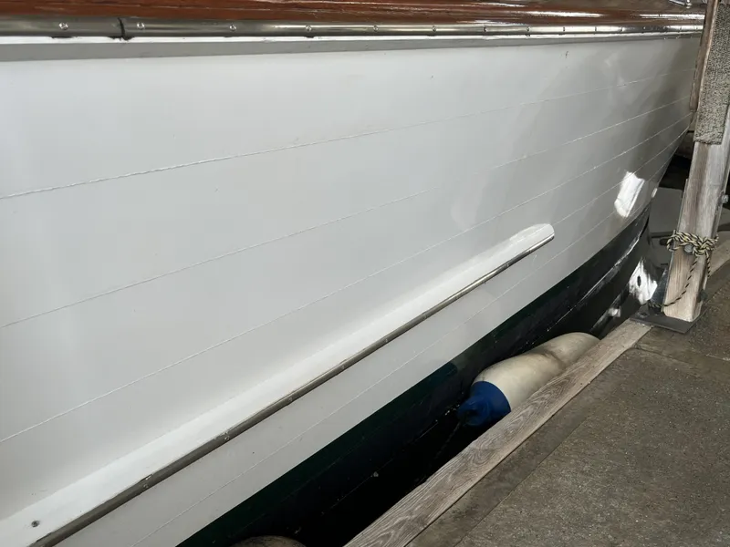 Slide: The Image of Side view of a 1959 Owens Cabin boat at dock. - 6