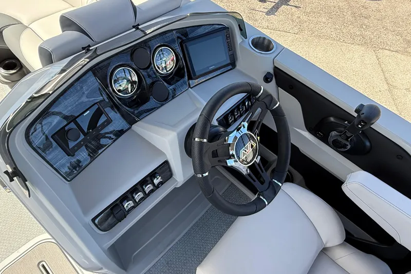 Slide: The Image of 2026 Avalon 2385 LSZ Quad Lounger dashboard with modern controls and steering wheel. - 15