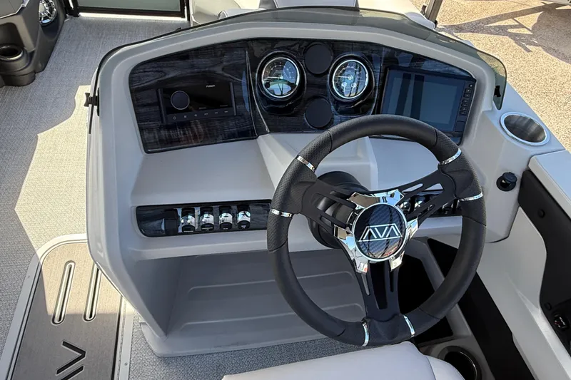 Slide: The Image of Steering console of 2026 Avalon 2385 LSZ Quad Lounger Tri Toon boat, featuring modern controls. - 16