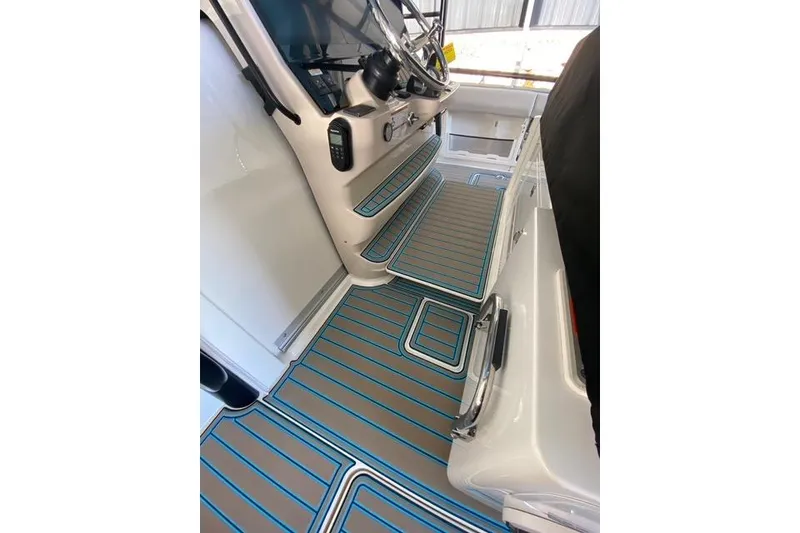 Slide: The Image of 2021 Boston Whaler 420 Outrage interior with modern helm and striped flooring. - 17