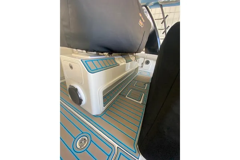 Slide: The Image of Interior view of a 2021 Boston Whaler 420 Outrage with blue-accented flooring. - 18