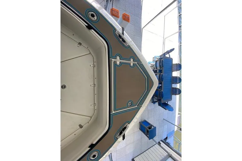 Slide: The Image of 2021 Boston Whaler 420 Outrage boat deck with blue accents in showroom. - 20