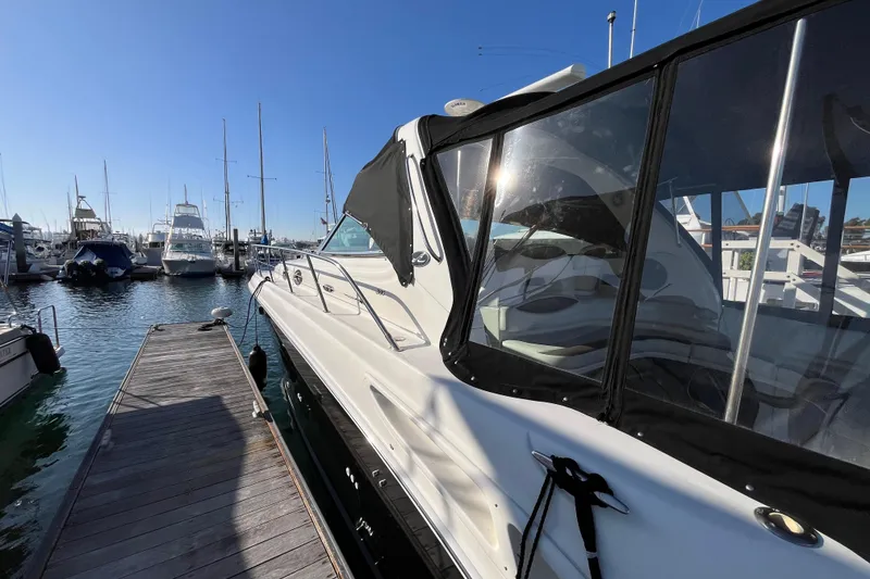 Slide: The Image of 2003 Searay 380 yacht docked at marina under clear blue sky. - 1