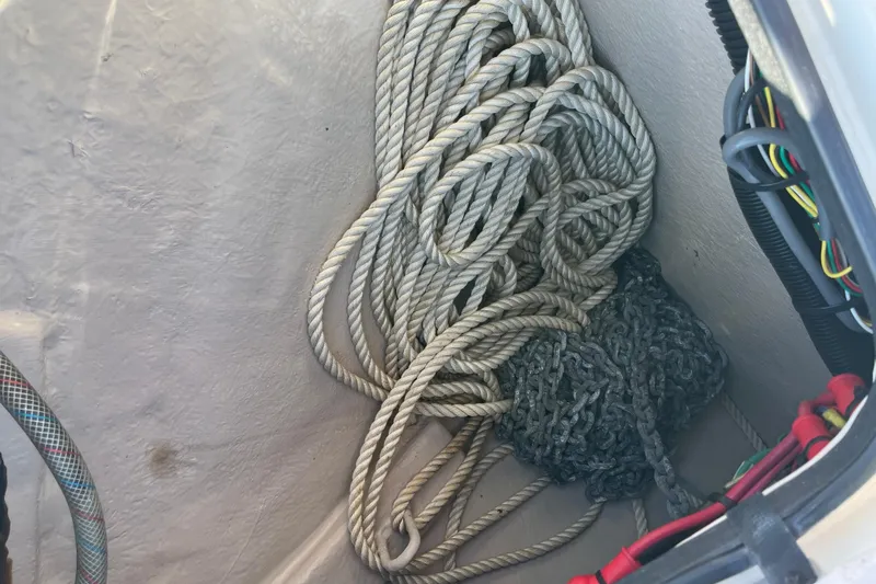 Slide: The Image of Coiled rope and chain in a 2003 Searay 380 boat compartment. - 11