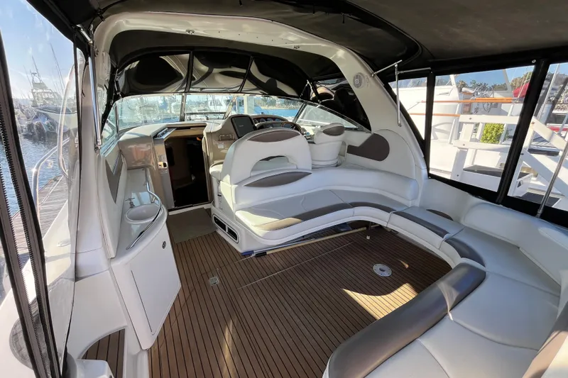 Slide: The Image of Interior of a 2003 Searay 380 boat with elegant seating and wood flooring. - 12