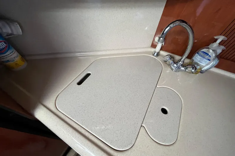 Slide: The Image of 2003 Searay 380 yacht kitchen sink with faucet and countertop cover. - 28