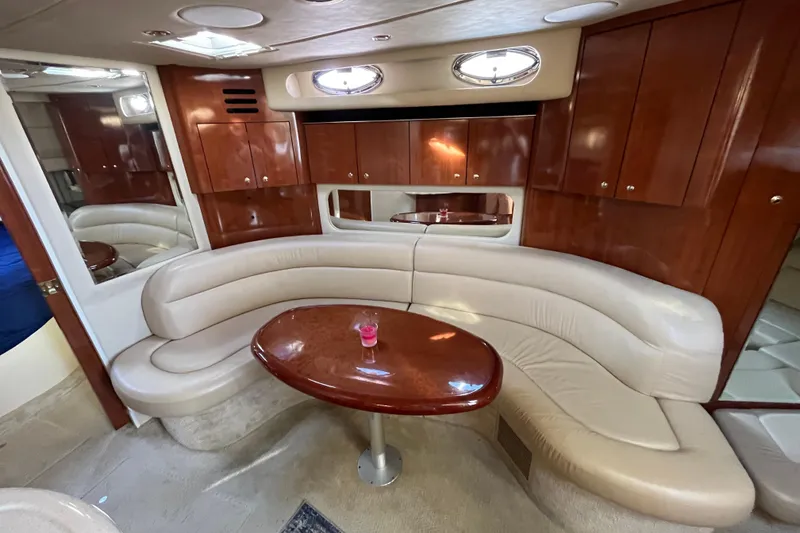 Slide: The Image of Luxurious interior of a 2003 Searay 380 yacht with leather seating and wooden cabinetry. - 30