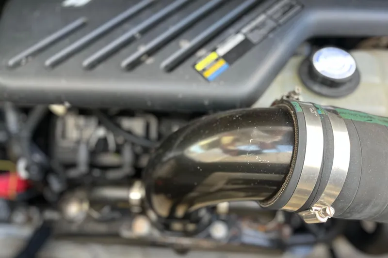 Slide: The Image of Close-up of a 2003 Searay 380 engine component with hose and clamps. - 42