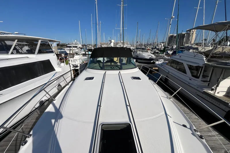 Slide: The Image of 2003 Searay 380 yacht docked at a marina, surrounded by other boats. - 5