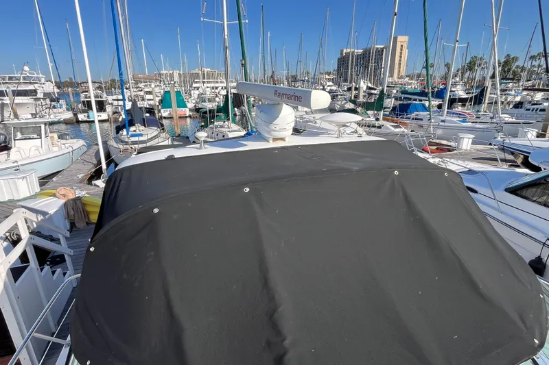 Slide: The Image of 2003 Searay 380 yacht docked in a busy marina with numerous sailboats. - 6