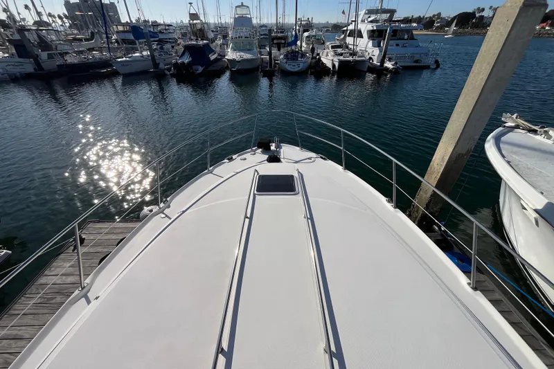 Slide: The Image of 2003 Searay 380 yacht docked at marina with sparkling water and boats. - 7