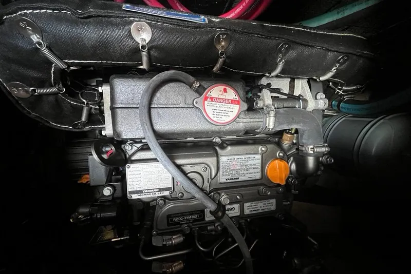 Slide: The Image of Engine compartment of a 1978 CAL 34 sailboat, featuring a Yanmar engine. - 13