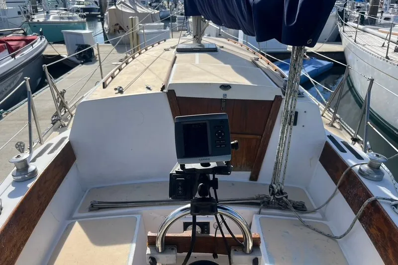 Slide: The Image of 1978 CAL 34 sailboat cockpit with navigation equipment, docked at marina. - 3