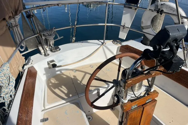 Slide: The Image of Cockpit of a 1978 CAL 34 sailboat with steering wheel and navigation equipment. - 4