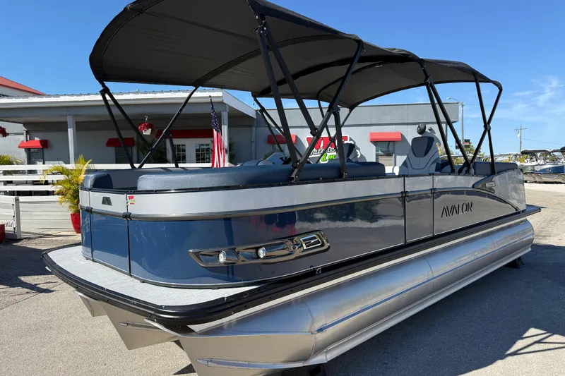 The Image of 2026 Avalon 2385 Catalina Quad Lounger Tri Toon boat with canopy, parked outdoors. - 1