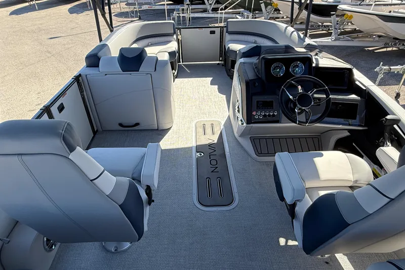 Slide: The Image of 2026 Avalon 2385 Catalina Quad Lounger interior with modern seating and steering console. - 12