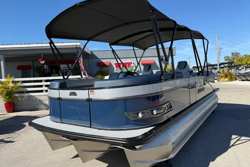 Slide: The Image of 2026 Avalon 2385 Catalina Quad Lounger Tri Toon, high-performance pontoon boat in showroom. - 2