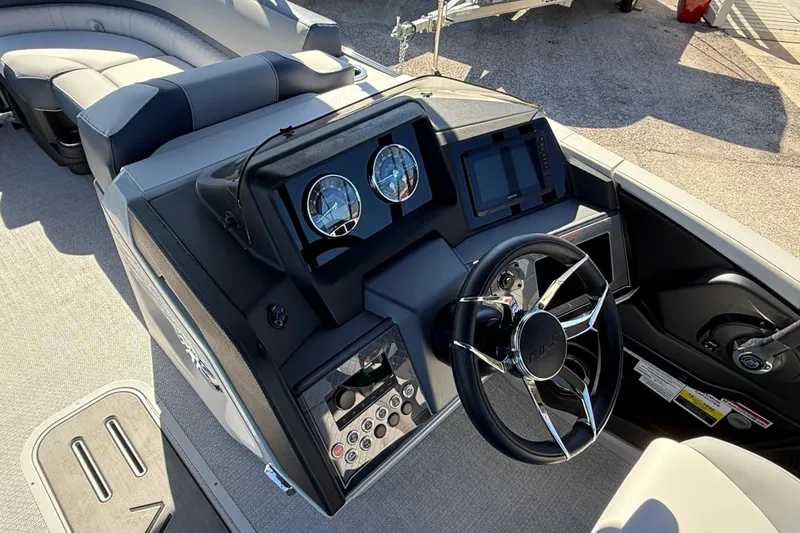 Slide: The Image of 2026 Avalon 2385 Catalina Quad Lounger dashboard with steering wheel and controls. - 25