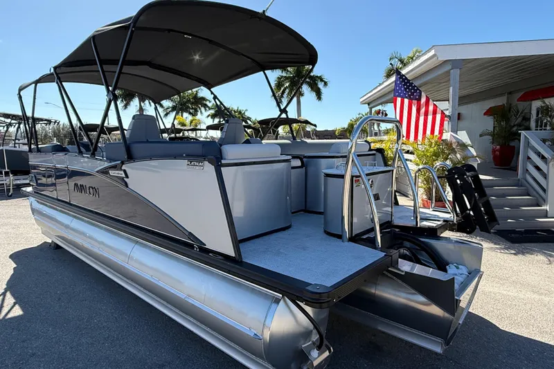 Slide: The Image of 2026 Avalon 2385 Catalina Quad Lounger Tri Toon, docked with American flag, sunny day. - 7