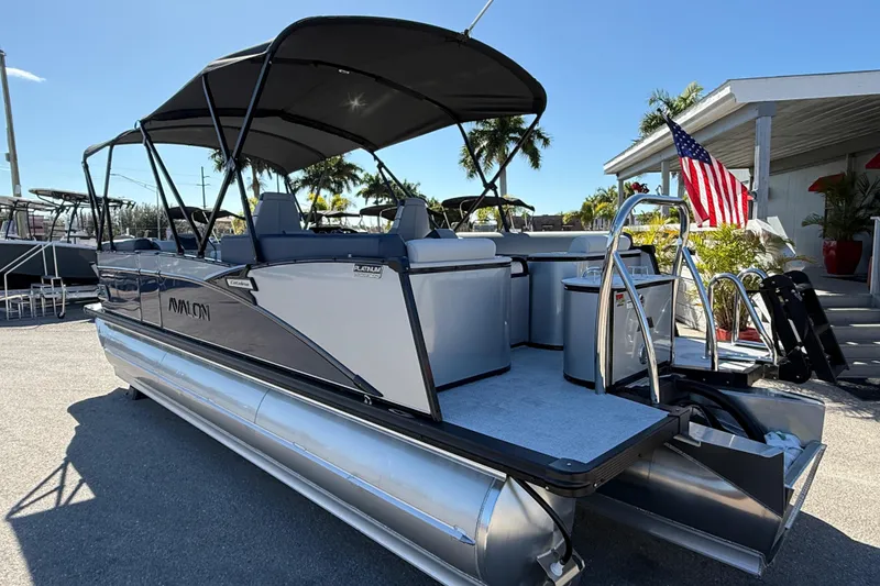 Slide: The Image of 2026 Avalon 2385 Catalina Quad Lounger, Tri Toon High Performance boat with canopy and American flag. - 8